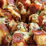 This Pizza Monkey Bread is the ultimate pull-apart snack, loaded with pepperoni, mozzarella, and parmesan cheese, all packed into bite-sized pieces of buttery biscuit dough. Perfect for parties, game days, or a fun family dinner!