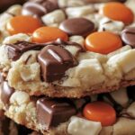 These indulgent cookies combine soft, chewy textures with creamy cheesecake flavors and the rich taste of Reese's candies. Each cookie is packed with Reese’s Pieces, Reese’s Peanut Butter Cups, white chocolate chips, and topped with a decadent chocolate drizzle.