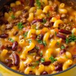 A delicious and hearty combination of homemade chili and creamy mac and cheese, topped with melted cheddar. This dish is perfect for cozy family dinners or game days, and it pairs wonderfully with cornbread!