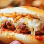 These oven baked meatball sandwiches are loaded with Italian meatballs, marinara, provolone, and mozzarella, baked to perfection in hoagie rolls. A cheesy, hearty meal!